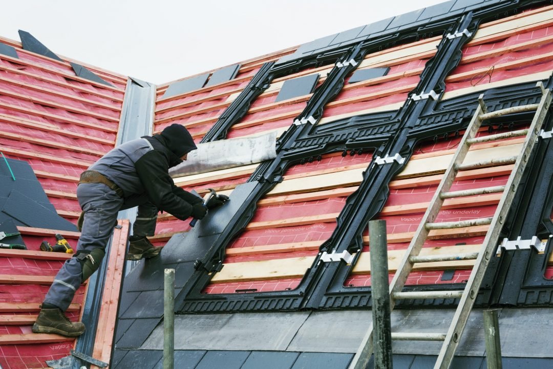 a-roofer-replacing-the-tiles-on-a-house-roof-.jpg